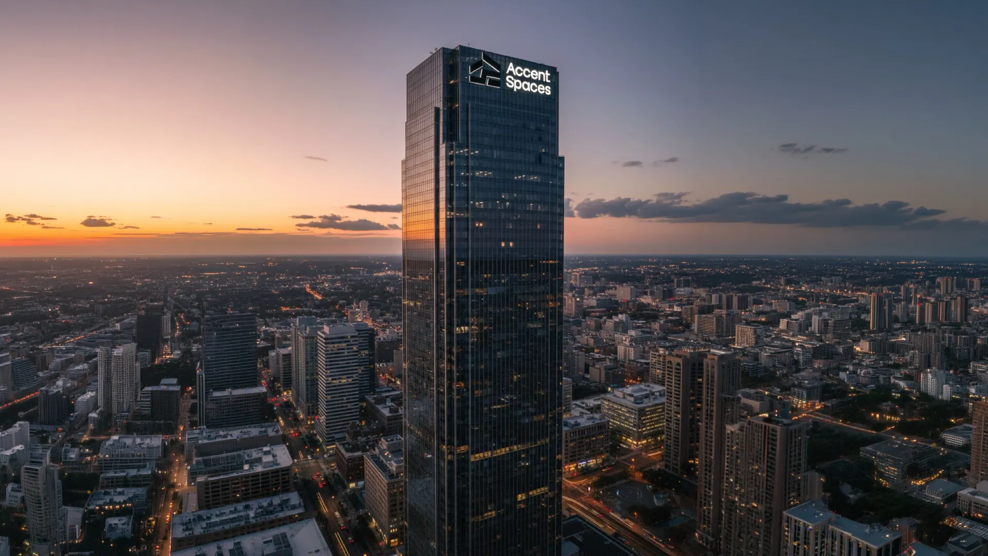 Accent Spaces logo lit on a skyscraper at dusk