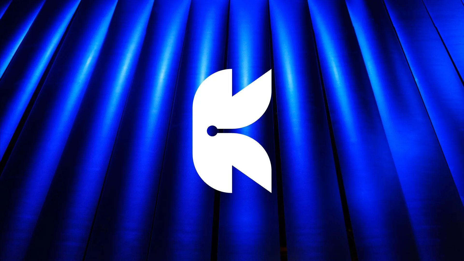 Kernel K mark in white over backlit blue pleated panels